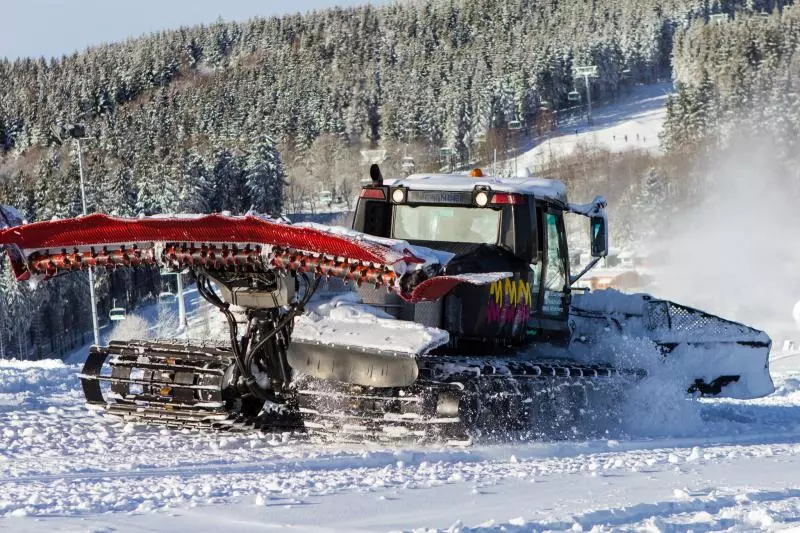 Piste groomer at work on a ski slope