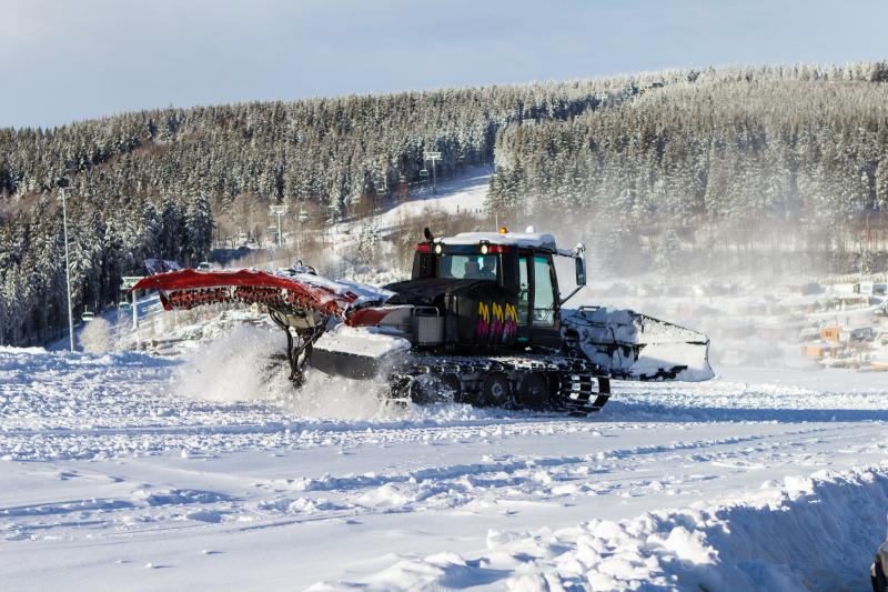 Piste groomer working in the snow