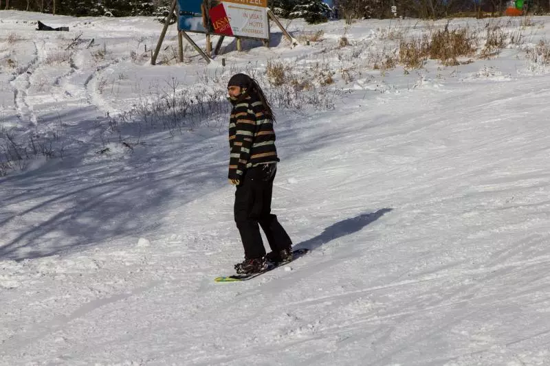 Snowboarder wearing snowboard trousers