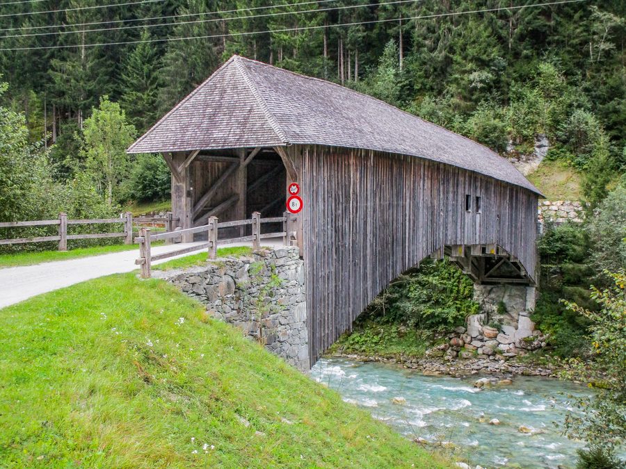 Covered wooden bridge over the Vorderrhein River near Rueun in the Surselva