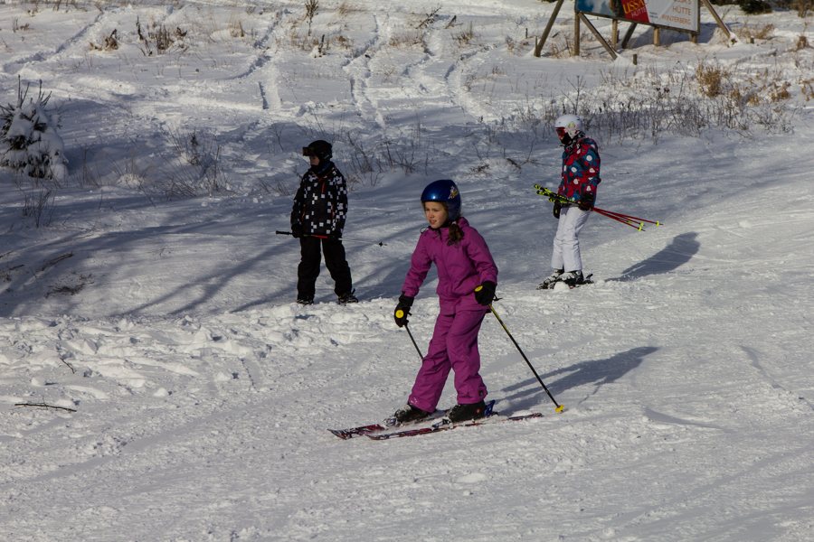 Children skiing on a snowy slope