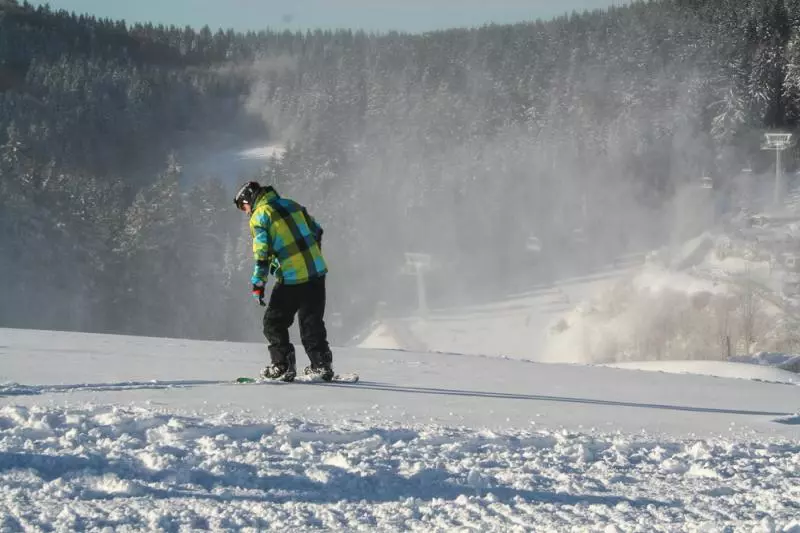 Snowboarder on a snowy piste