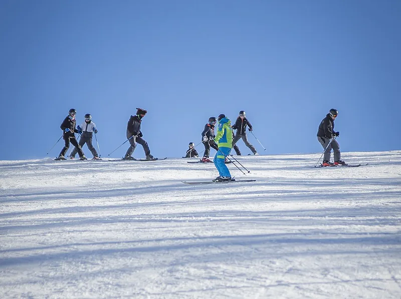 Ski instructor briefing a group on a snowy slope